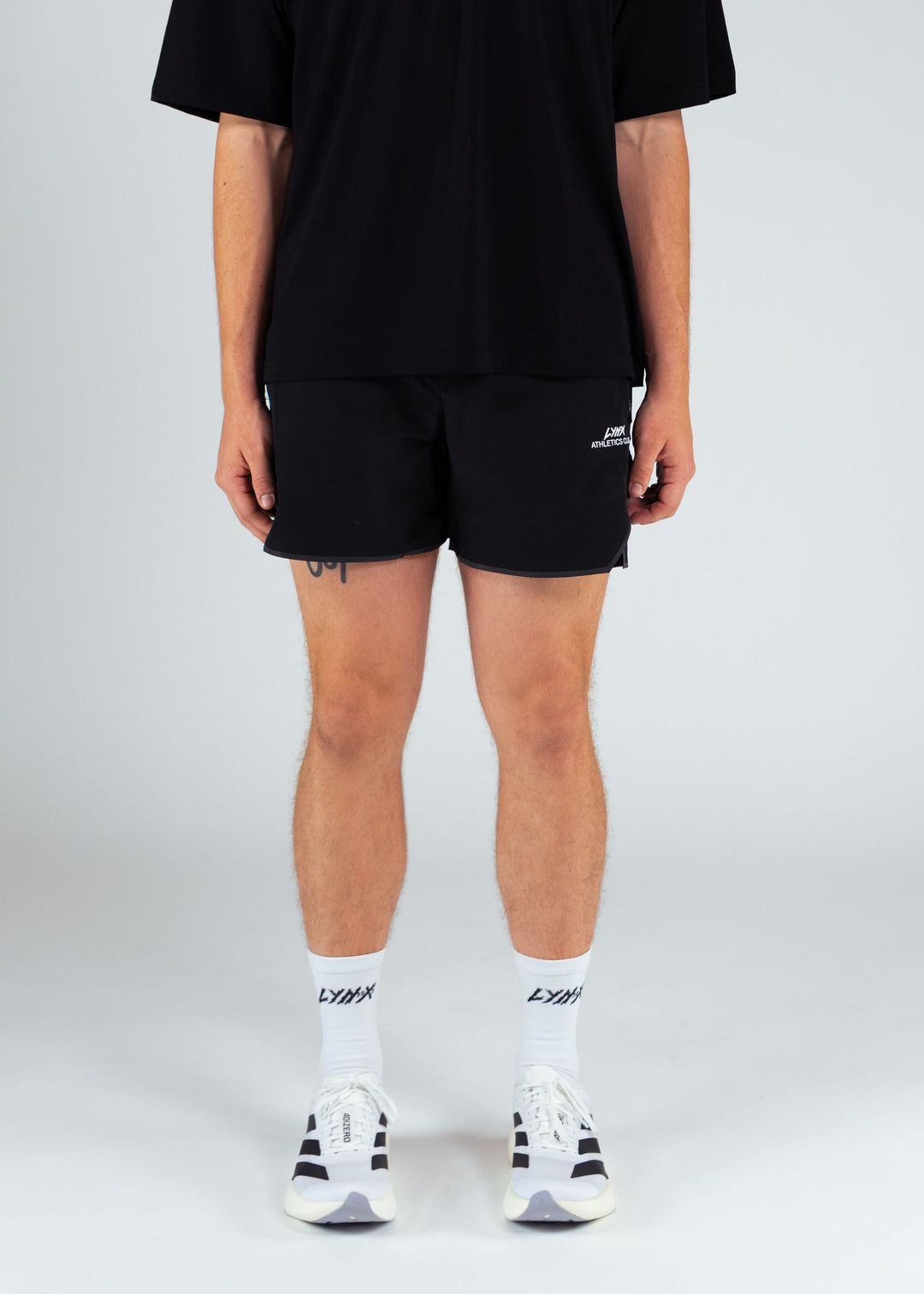 person wearing black lynx athletics club tee