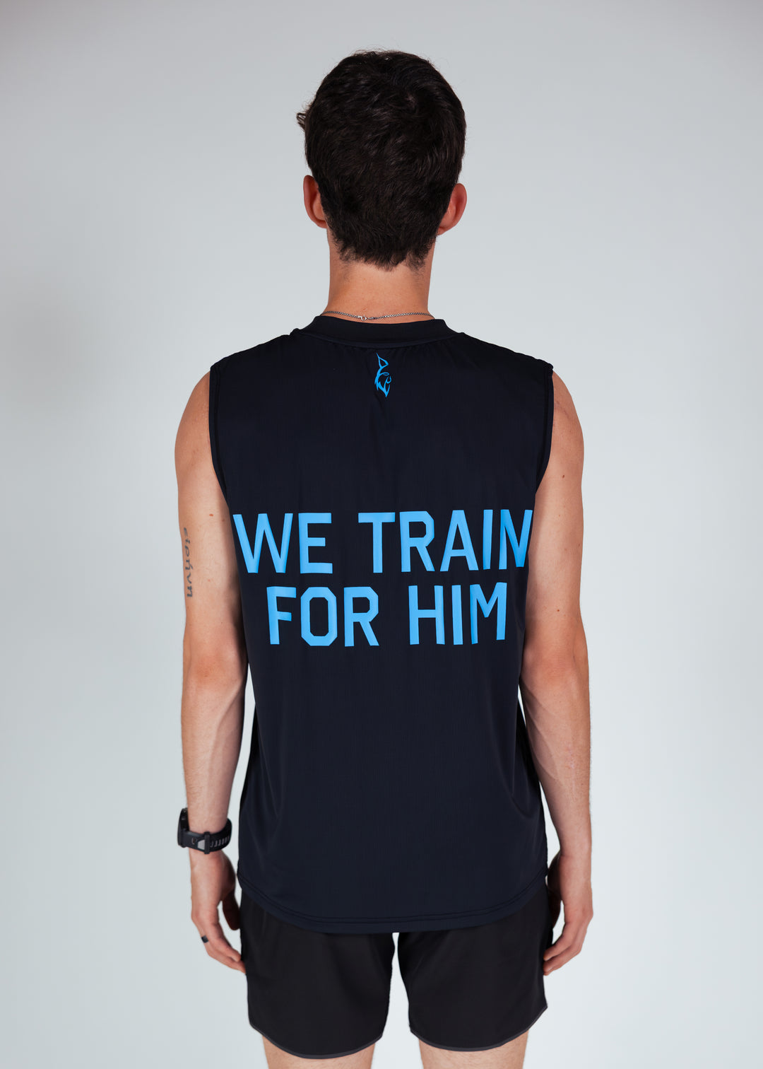 person wearing we train for him running tank