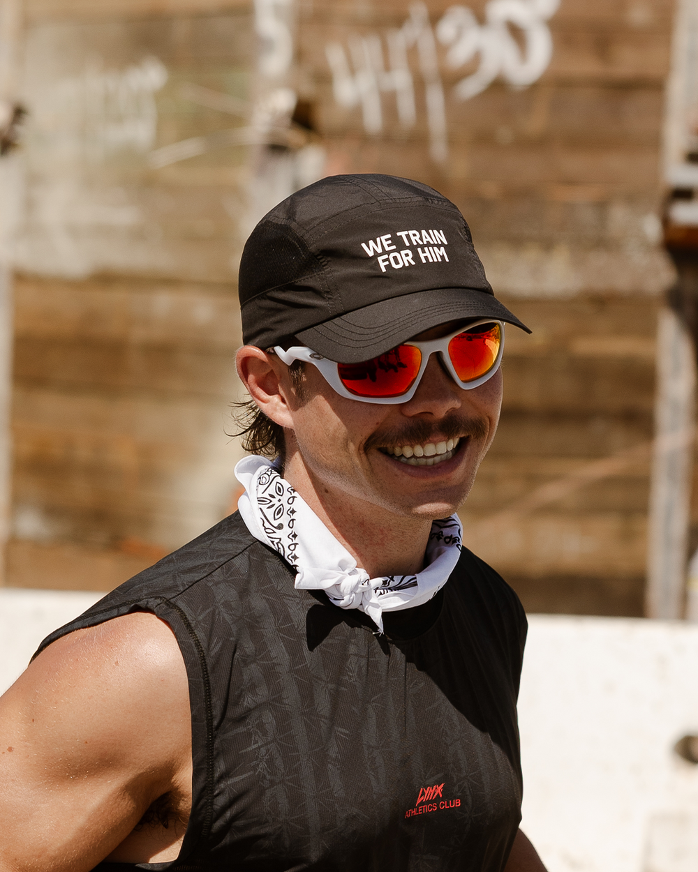 athlete wearing we train for him running hat
