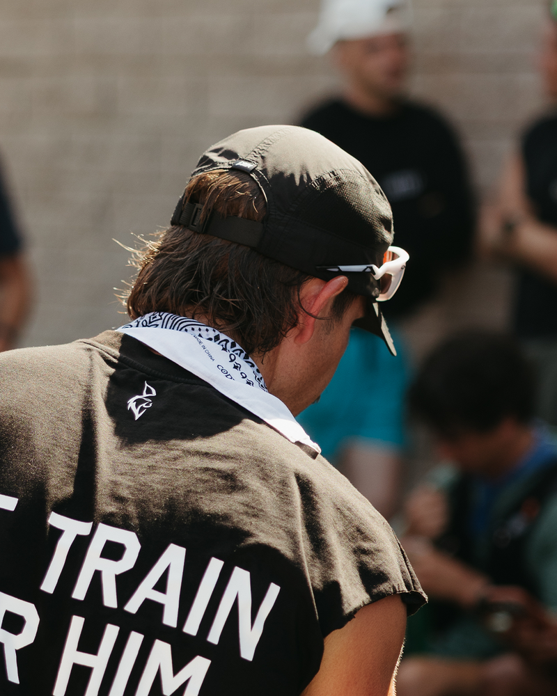 athlete wearing we train for him tee and hat.