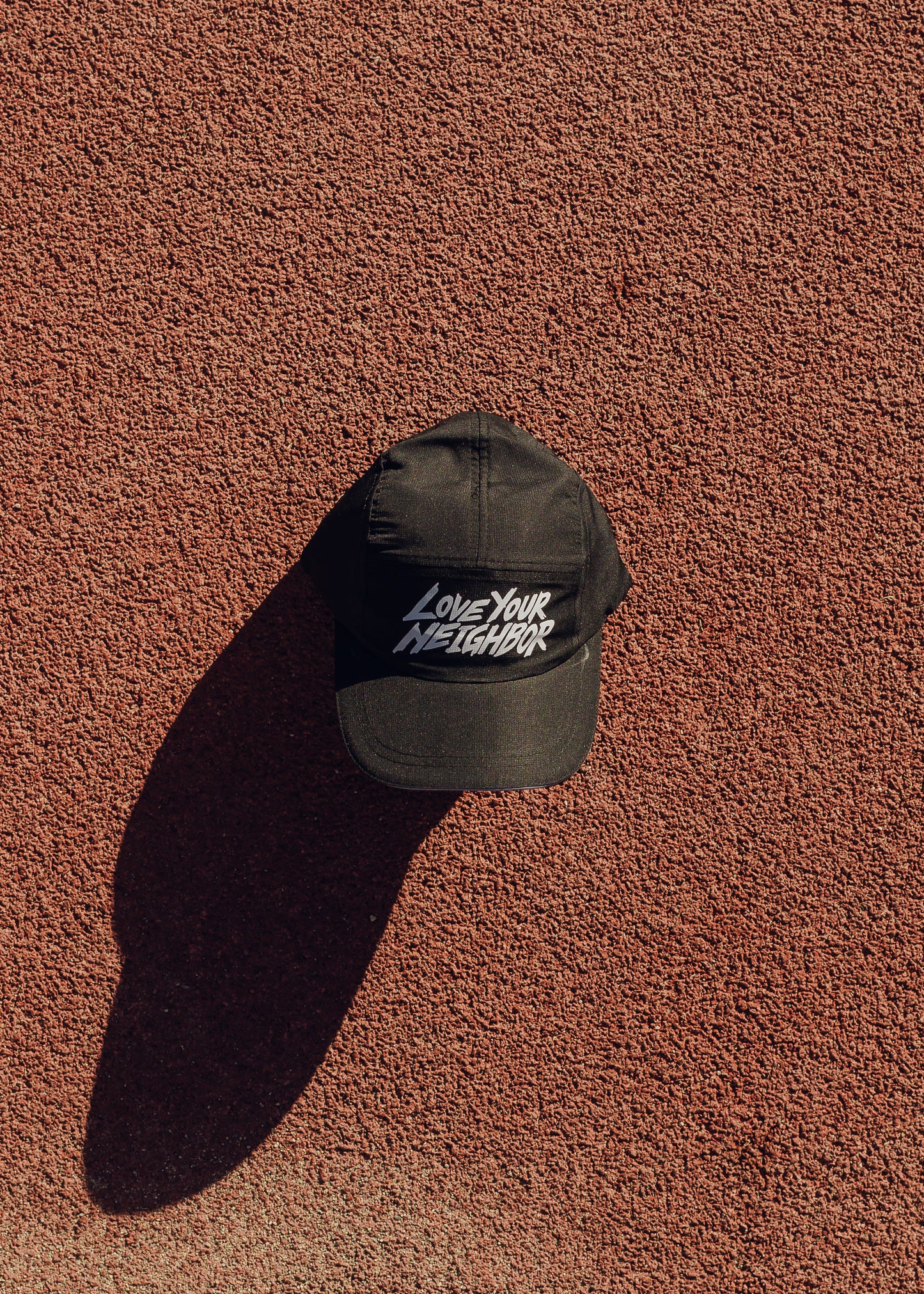 "LOVE YOUR NEIGHBOR" RUN HAT IN BLACK