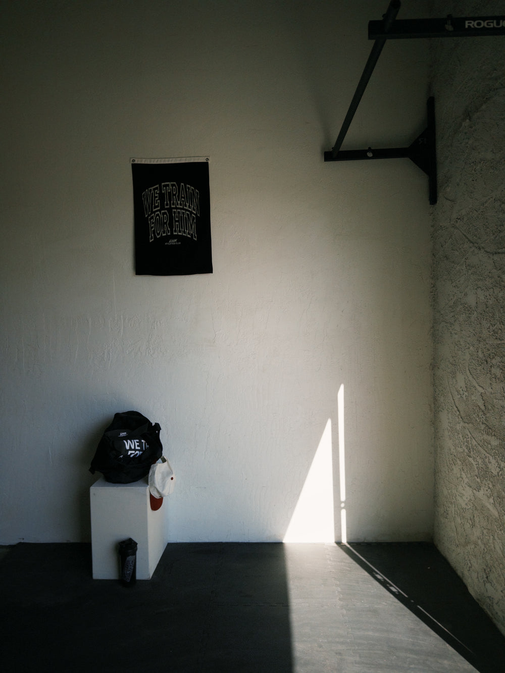 gym corner with we train for him flag