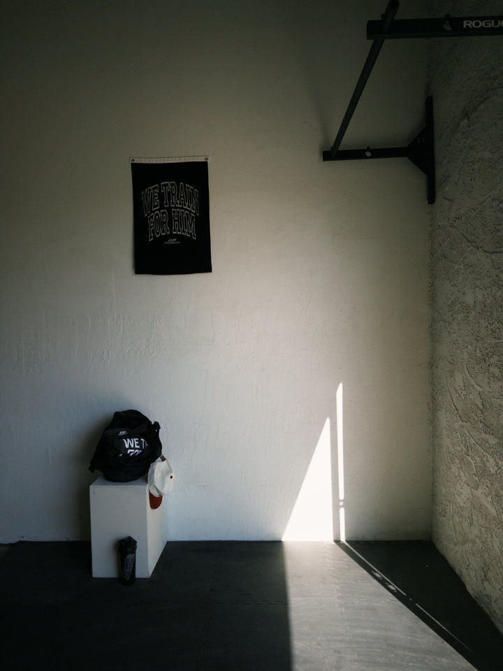 gym corner with we train for him flag